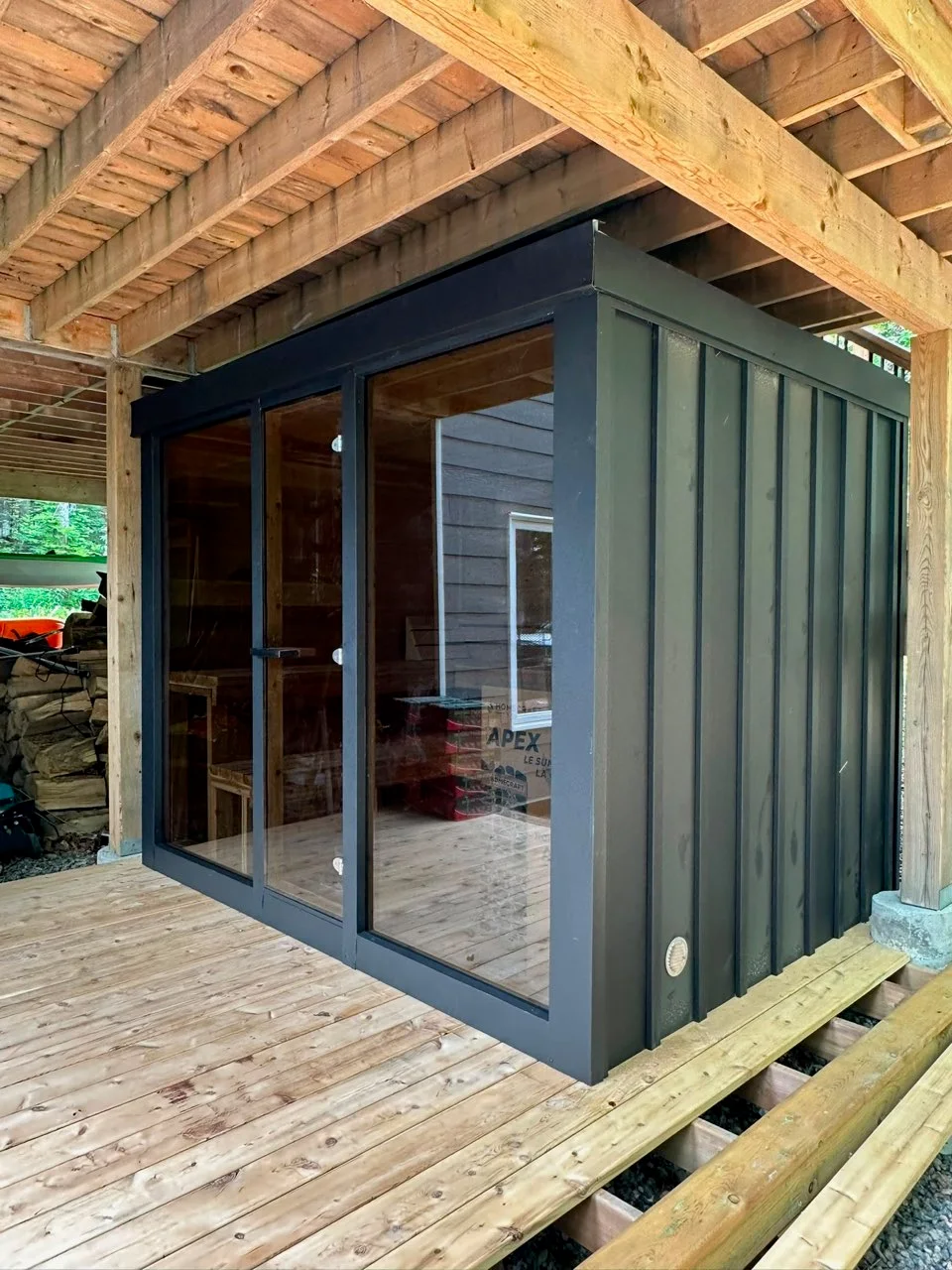 Detail view of fitted black metal cladding on an installed Cube sauna